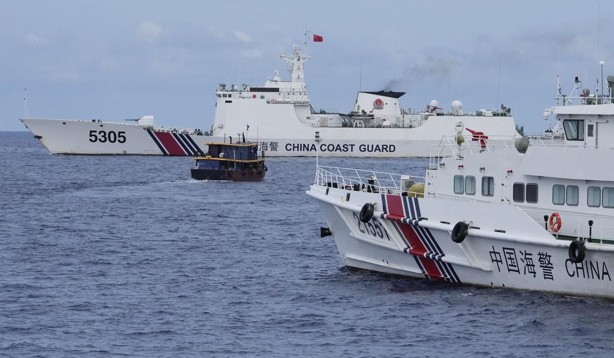 NextImg:Philippine boats breach a Chinese coast guard blockade in a faceoff near a disputed shoal