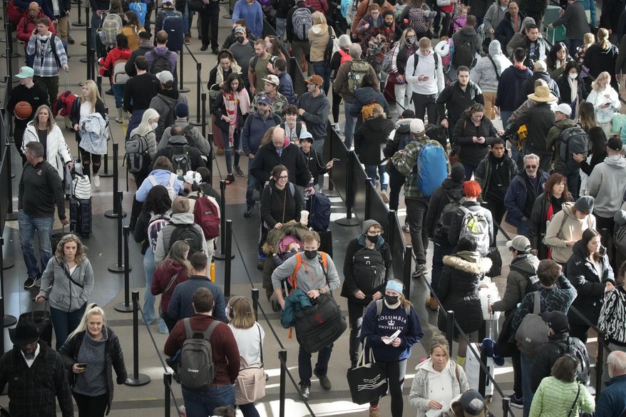 Travelers queue up to pass through the south security checkpoint in Denver International Airport on Dec. 23, 2022, in Denver. (AP Photo/David Zalubowski) **FILE**