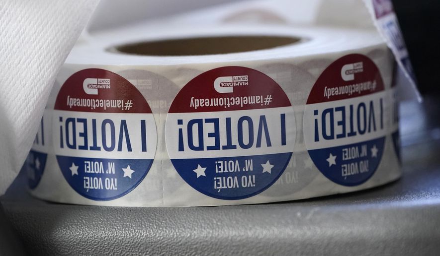 A roll of "I Voted!" stickers are shown, Oct. 6, 2020, at the Miami-Dade County Elections Department in Doral, Fla. A Florida man has been arrested on forgery and fraud charges after authorities say he cast a ballot for his deceased father in the 2020 election. (AP Photo/Wilfredo Lee, File)