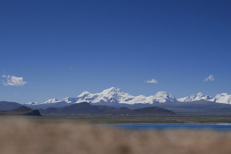 In this photo released by Xinhua News Agency, Mount Shishapangma is seen from Baiku Lake in Xigaze, southwest China's Tibet Autonomous Region on Sept. 2, 2023. American mountaineer Anna Gutu and a Nepalese guide Mingmar Sherpa were confirmed dead Sunday, Oct. 8, after avalanches struck the slopes of a Tibetan mountain, while two others remained missing, according to Chinese media reports. (Chen Zepeng/Xinhua via AP)