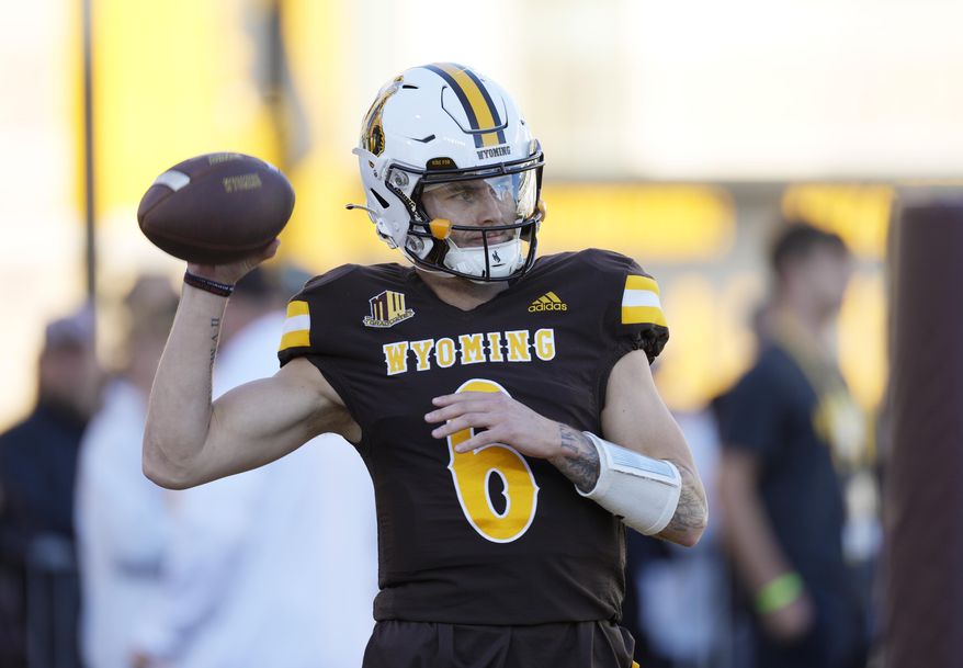 Wyoming quarterback Andrew Peasley warms up for the team's NCAA college football game against Fresno State on Saturday, Oct. 7, 2023, in Laramie, Wyo. (AP Photo/David Zalubowski)