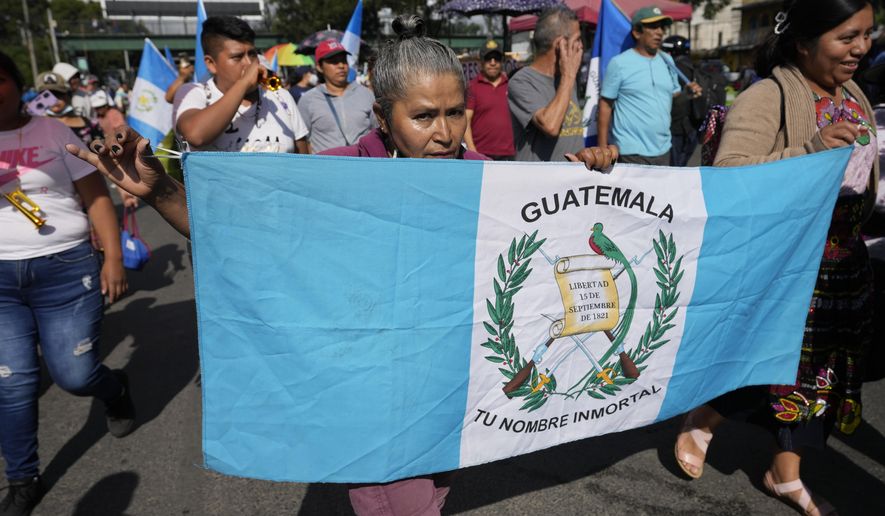 Market vendors march toward downtown during a national strike in Guatemala City, Monday, Oct. 9, 2023. People are protesting to support President-elect Bernardo Arévalo after Guatemala's highest court upheld a move by prosecutors to suspend his political party over alleged voter registration fraud. (AP Photo/Moises Castillo)