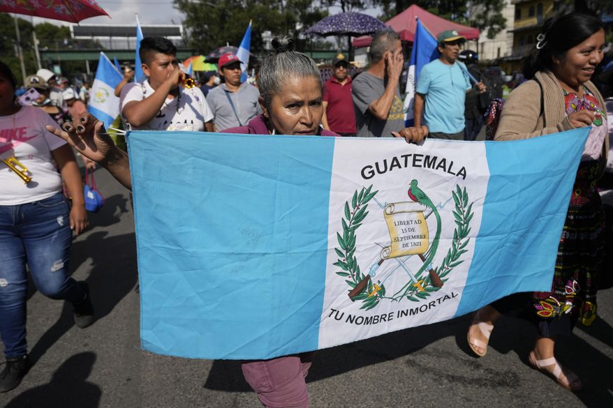 Market vendors march toward downtown during a national strike in Guatemala City, Monday, Oct. 9, 2023. People are protesting to support President-elect Bernardo Arévalo after Guatemala's highest court upheld a move by prosecutors to suspend his political party over alleged voter registration fraud. (AP Photo/Moises Castillo)