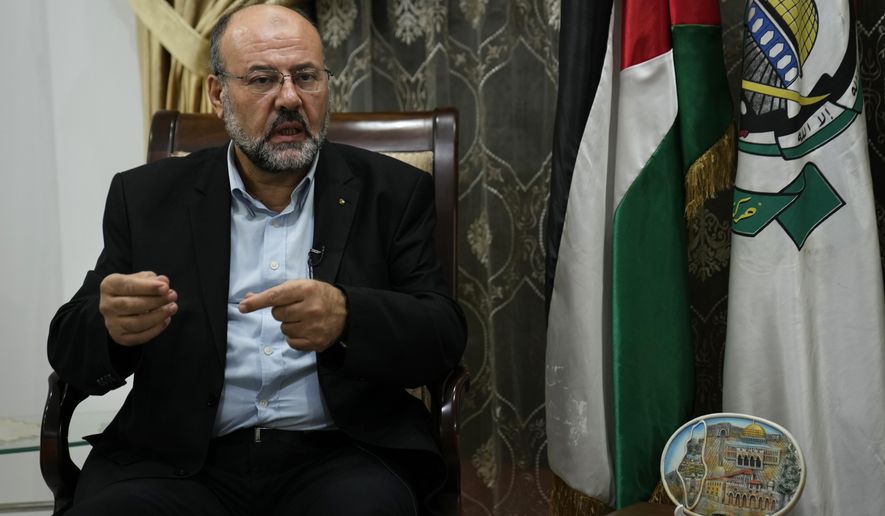 Ali Barakeh, a member of Hamas’ exiled leadership, speaks during an interview with The Associated Press in Beirut, Lebanon, Monday, Oct. 9, 2023. Barakeh on Monday denied that Iran or the Lebanese Hezbollah had helped plan or were even aware of the wide-ranging incursion his group launched into Israel, but said “our allies will join the battle if Gaza is subjected to a war of annihilation.” (AP Photo/Hussein Malla)