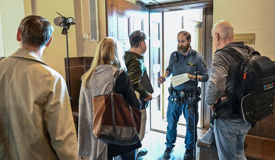 People wait outside a courtroom at the Stockholm District Court for the trial of a Russian-born Swedish citizen charged with collecting information for the Russian military intelligence service GRU for almost a decade, in Stockholm, on Sept. 4, 2023. A Swedish court on Monday, Oct. 9, 2023, released a Russia-born Swedish citizen charged with collecting information for the Russian military intelligence service GRU for almost a decade. Sergey Skvortsov, 60, is accused of “gross illegal intelligence activities against Sweden and against a foreign power,” namely the United States. Skvortsov, who is awaiting a verdict in his trial which ended Sept. 28, was released with the Stockholm District Court saying that “there is no longer reason to keep the defendant in custody.” The verdict is due Oct. 26. (Jonas Ekstromer/TT News Agency via AP)