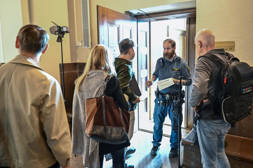 People wait outside a courtroom at the Stockholm District Court for the trial of a Russian-born Swedish citizen charged with collecting information for the Russian military intelligence service GRU for almost a decade, in Stockholm, on Sept. 4, 2023. A Swedish court on Monday, Oct. 9, 2023, released a Russia-born Swedish citizen charged with collecting information for the Russian military intelligence service GRU for almost a decade. Sergey Skvortsov, 60, is accused of “gross illegal intelligence activities against Sweden and against a foreign power,” namely the United States. Skvortsov, who is awaiting a verdict in his trial which ended Sept. 28, was released with the Stockholm District Court saying that “there is no longer reason to keep the defendant in custody.” The verdict is due Oct. 26. (Jonas Ekstromer/TT News Agency via AP)