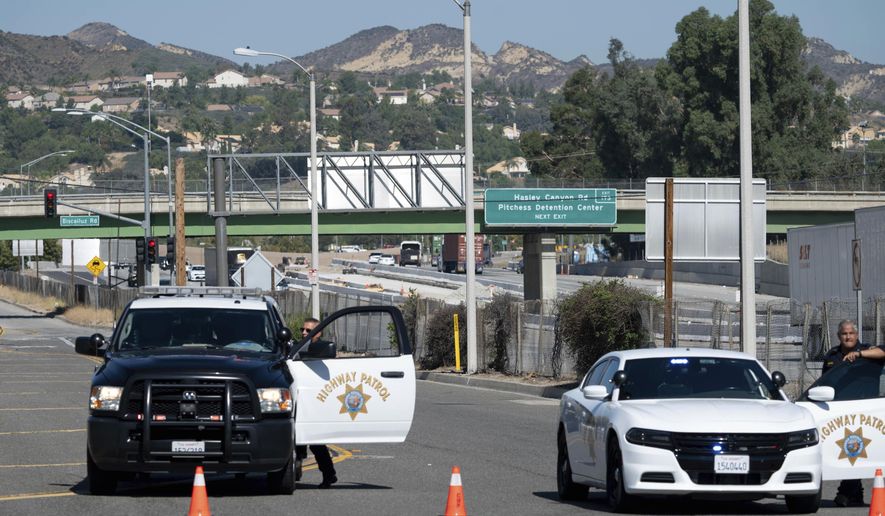 California Highway Patrol and sheriffs block off The Old Road with access to Pitchess Detention Center in Castaic, Calif, Tuesday, Oct. 10, 2023. A spokesman says four Los Angeles County sheriff's deputies were taken to the hospital Tuesday morning after a fire during a "training incident" north of Los Angeles. (David Crane/The Orange County Register via AP)