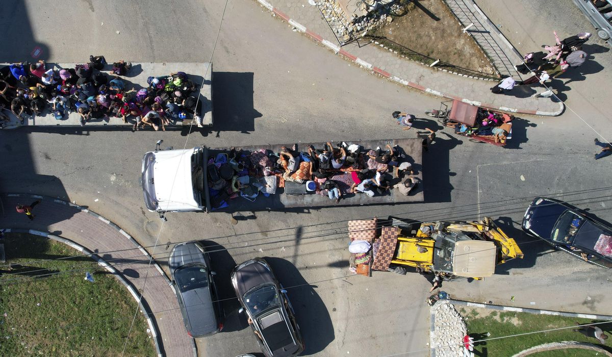NextImg:Palestinians in Gaza face impossible choice: Stay home under airstrikes, or flee under airstrikes?