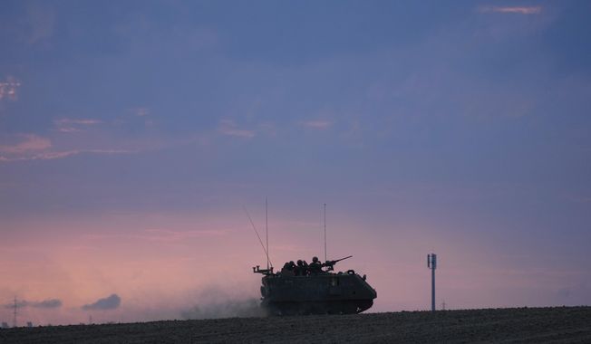 An Israeli armoured personnel carrier (APC) heads towards the Gaza Strip border in southern Israel on Saturday, Oct. 14, 2023. (AP Photo/Maya Alerruzzo)