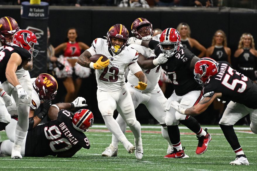 Washington Commanders running back Chris Rodriguez Jr. (23) running with the ball during the second half of an NFL game against the Atlanta Falcons at Mercedes-Benz Stadium in Atlanta, GA, October 15, 2023. (Photo by Billy Sabatini)