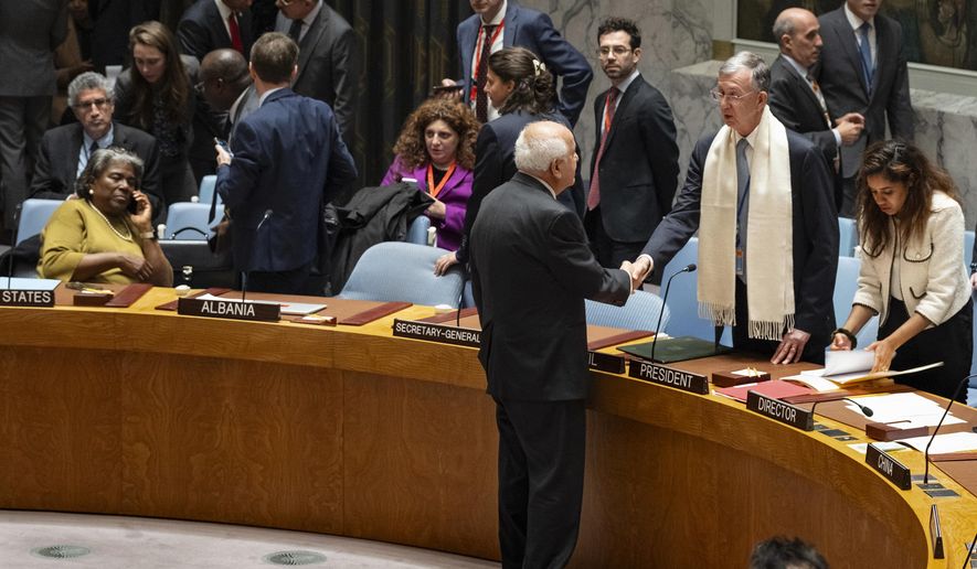 Palestinian Observer to the United Nations, Riyad Mansour, faces and shakes hands with Security Council President and Brazilian Ambassador to the United Nations Sergio Franca Danese before members of the the U.N. Security Council went into closed consultations at United Nations headquarters Monday, Oct. 16, 2023. A planned vote on dueling resolutions on the Israel-Hamas war was delayed as a result, but the council remained in session. (AP Photo/Craig Ruttle)