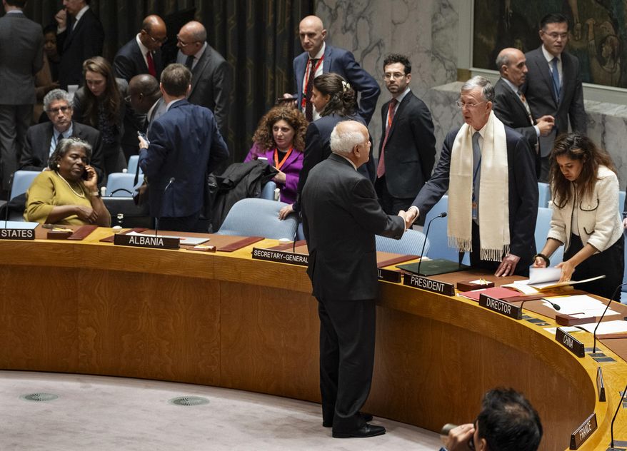 Palestinian Observer to the United Nations, Riyad Mansour, faces and shakes hands with Security Council President and Brazilian Ambassador to the United Nations Sergio Franca Danese before members of the the U.N. Security Council went into closed consultations at United Nations headquarters Monday, Oct. 16, 2023. A planned vote on dueling resolutions on the Israel-Hamas war was delayed as a result, but the council remained in session. (AP Photo/Craig Ruttle)