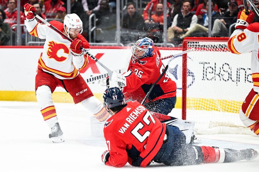 Washington Capitals goalie Darcy Kuemper (35) battles Calgary Flames left wing Jonathan Huberdeau (10) for a loose puck during the second period at Capital One Arena, Washington, D.C., October 16, 2023. (Photo by Brian Murphy for the Washington Times)