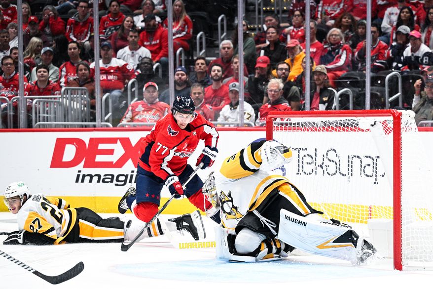 Washington Capitals right wing T.J. Oshie (77) tries to control a bouncing puck against the Pittsburgh Penguins at Capital One Arena, Washington, D.C., October 13, 2023. (Photo by Brian Murphy for the Washington Times)