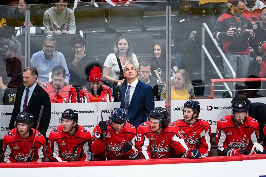 Washington Capitals coach Spencer Carbery watches a replay as his team faces the Pittsburgh Penguins at Capital One Arena, Washington, D.C., October 13, 2023. (Photo by Brian Murphy for the Washington Times)