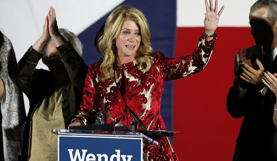 Then-Texas Democratic gubernatorial candidate Wendy Davis waves to supporters after making her concession speech, Nov. 4, 2014, in Fort Worth, Texas. In a settlement revealed Wednesday, Oct. 18, 2023, city of San Marcos, Texas, officials agreed to pay $175,000 to former Texas state Sen. Davis and three others who were harassed by supporters of former president Donald Trump while campaigning for President Joe Biden in 2020, according to a legal settlement. (AP Photo/Tony Gutierrez, File)