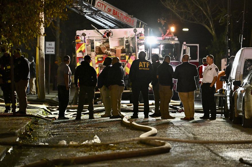 First responders work the scene after a deadly fire on Tuesday, Oct. 19, 2023, in Baltimore. (Jerry Jackson/The Baltimore Sun via AP)