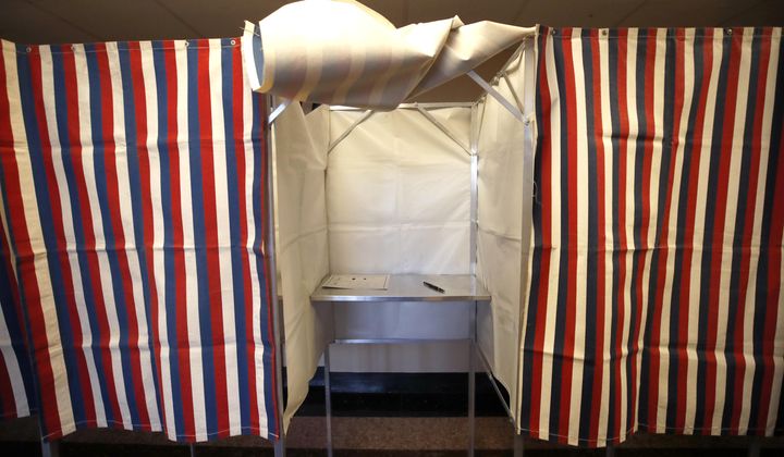 A booth is ready for a voter, Feb. 24, 2020, at City Hall in Cambridge, Mass., on the first morning of early voting in the state. The U.S. is warning other democracies that Russia appears to be opening up a new front in its covert campaign against democracy — sowing doubts about the reliability of elections in general. Encouraged by its success amplifying doubts about election procedures like mail balloting used in the 2020 U.S. presidential election, Russian intelligence is trying to do the same in several other countries, according to U.S. intelligence. (AP Photo/Elise Amendola, File)