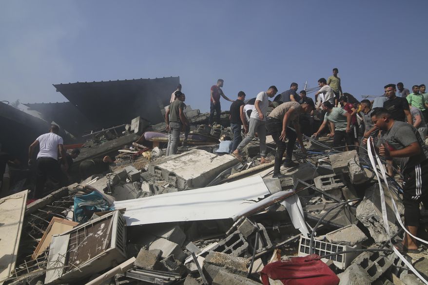 Palestinians look for survivors of the Israeli bombardment of the Gaza Strip in Rafah on Monday, Oct. 23, 2023. (AP Photo/Hatem Ali)
