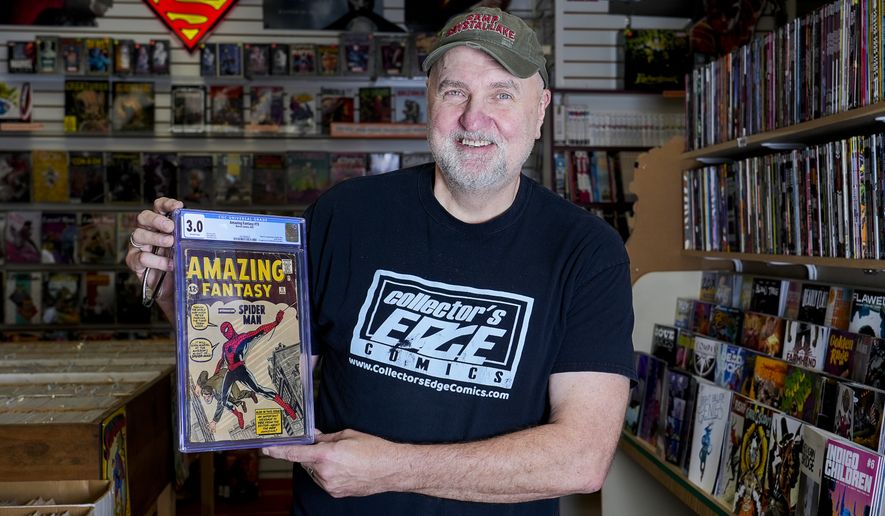 Steve Dobrzynski, owner of Collector's Edge Comics, holds an Amazing Fantasy #15 Marvel comic which is the first appearance of the Amazing Spider-Man on Wednesday, Oct. 18, 2023 in Milwaukee, Wis. (Jovanny Hernandez/ Milwaukee Journal-Sentinel via AP)