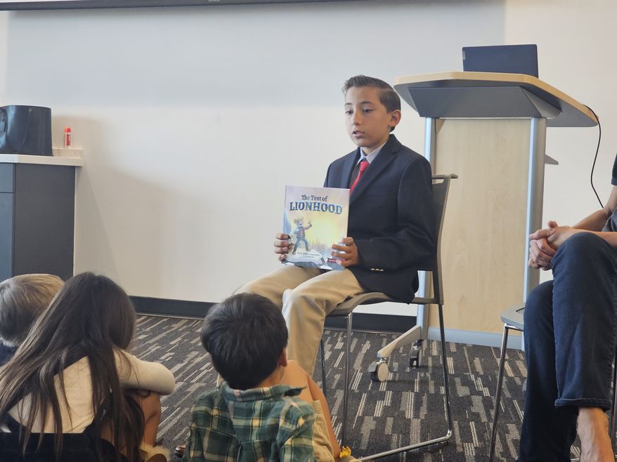 Jaiden Rodriguez, 12, a student at the Vanguard School in Colorado Springs, Colorado, reads to children during a Brave Books story hour in Castle Rock, Colorado, on Sept. 30, 2023. (Valerie Richardson/The Washington Times)