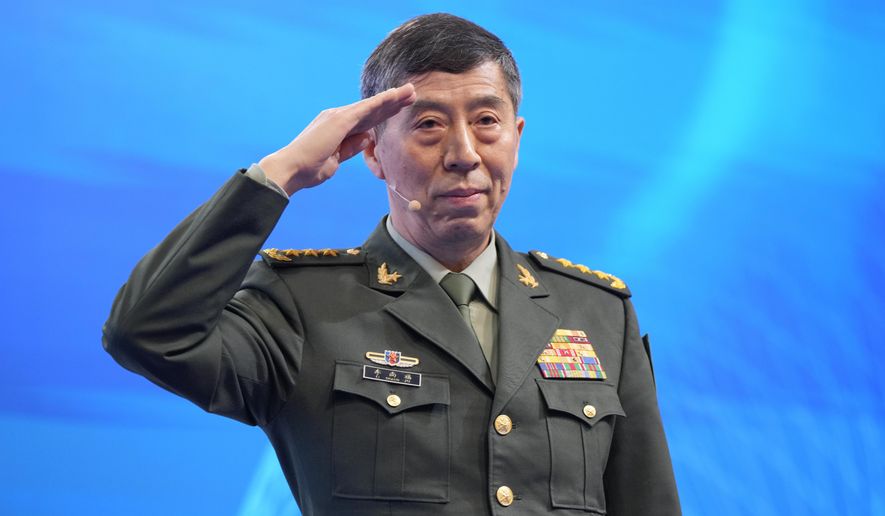 Chinese Defense Minister Li Shangfu salutes before delivering his speech on the last day of the 20th International Institute for Strategic Studies (IISS) Shangri-La Dialogue, Asia's annual defense and security forum, in Singapore, on June 4, 2023. China has replaced Defense Minister Gen. Li, who has been out of public view for almost two months with little explanation, state media reported Tuesday, Oct. 24. (AP Photo/Vincent Thian, File)