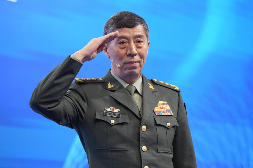 Chinese Defense Minister Li Shangfu salutes before delivering his speech on the last day of the 20th International Institute for Strategic Studies (IISS) Shangri-La Dialogue, Asia's annual defense and security forum, in Singapore, on June 4, 2023. China has replaced Defense Minister Gen. Li, who has been out of public view for almost two months with little explanation, state media reported Tuesday, Oct. 24. (AP Photo/Vincent Thian, File)