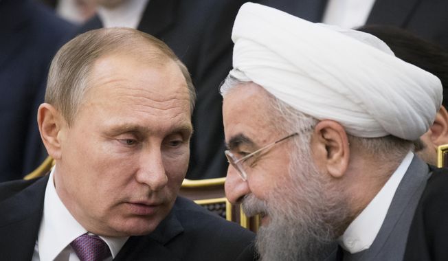 Russian President Vladimir Putin, left, and Iran&#x27;s President Hassan Rouhani talk to each other as they attend a signing ceremony during the Gas Exporting Countries Forum (GECF) in Tehran, Iran, Monday, Nov. 23, 2015. Putin declared earlier this month that Moscow could play the role of mediator to help end the Israel-Hamas war, thanks to its friendly ties with both Israel and the Palestinians, adding that &quot;no one could suspect us of playing up to one party.&quot; (AP Photo/Alexander Zemlianichenko, File)