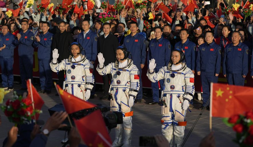 Chinese astronauts for the Shenzhou-17 mission, from left, Jiang Xinlin, Tang Hongbo and Tang Shengjie wave as they attend a send-off ceremony for their manned space mission at the Jiuquan Satellite Launch Center in northwestern China, Thursday, Oct. 26, 2023. (AP Photo/Andy Wong) ** FILE **