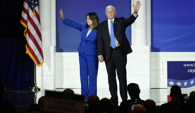 Karen Pence, left, and former Vice President Mike Pence wave to the crowd at an annual leadership meeting of the Republican Jewish Coalition, Saturday, Oct. 28, 2023, in Las Vegas. (AP Photo/John Locher)