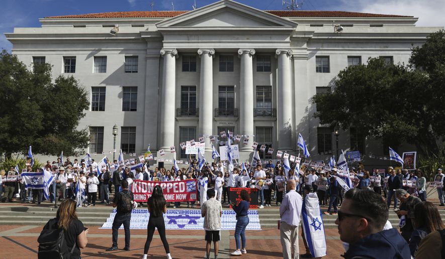 People hold flags and signs as they participate in a rally held in support of Israel at University of California, Berkeley campus in Berkeley, Calif., Friday, Oct. 27, 2023. (Jessica Christian/San Francisco Chronicle via AP)