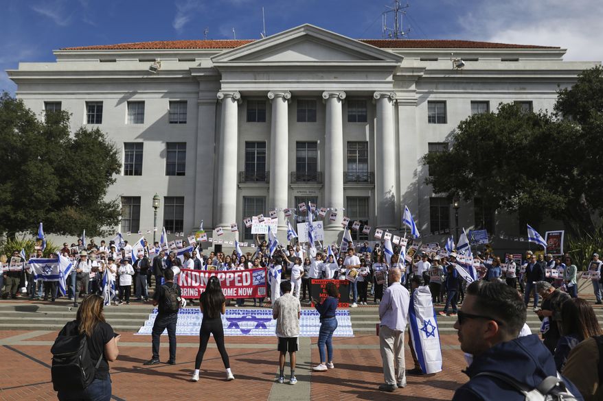 People hold flags and signs as they participate in a rally held in support of Israel at University of California, Berkeley campus in Berkeley, Calif., Friday, Oct. 27, 2023. (Jessica Christian/San Francisco Chronicle via AP)