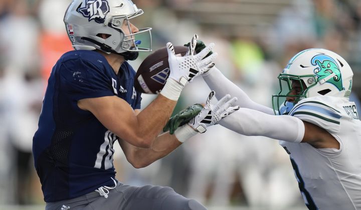 Rice wide receiver Luke McCaffrey, left, catches a pass for a touchdown as Tulane safety Kam Pedescleaux defends during the second half of an NCAA college football game, Saturday, Oct. 28, 2023, in Houston. (AP Photo/Eric Christian Smith)