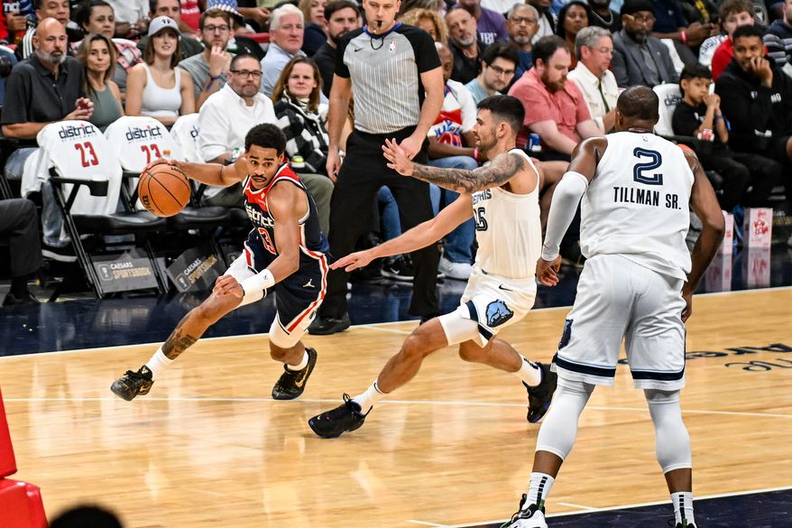 Washington, D.C.: Guard Jordan Poole (13) drives past his opponent on the way to the basket. The Washington Wizards defeat the Memphis Grizzlies in their home season opener from the Capital One Arena in Washington, D.C. on October 28th, 2023. (Photo: Joe Glorioso | Washington Times Sports)