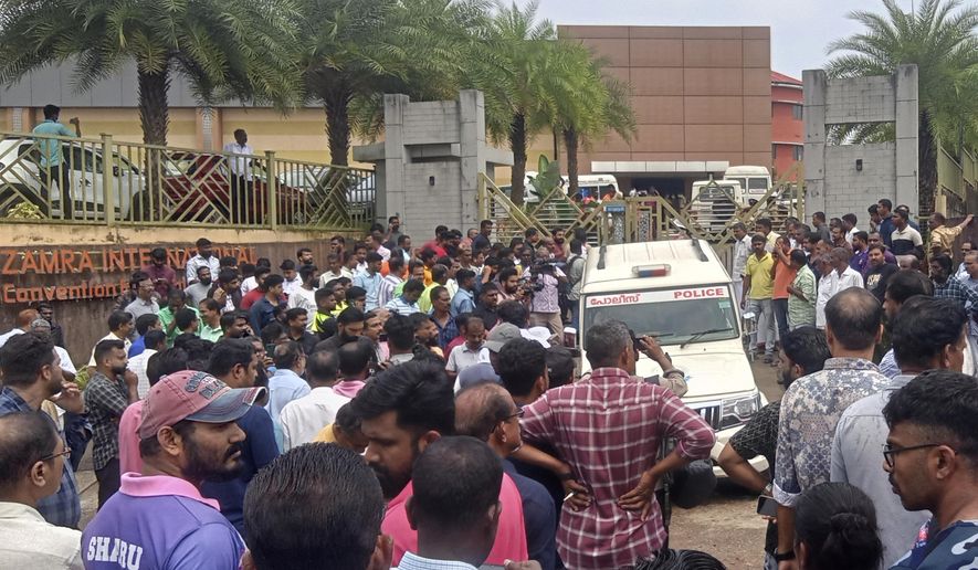People gather outside following a blast at the Zamra convention center in Kalamassery, a town in Kochi, southern Kerala state, India, Sunday, Oct.29, 2023. At least one person died and more than 20 were injured in the explosion, authorities said. (AP Photo)