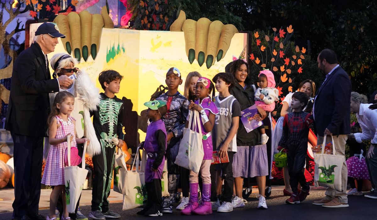 NextImg:President and first lady hand out books and candy for rainy trick or treating at White House