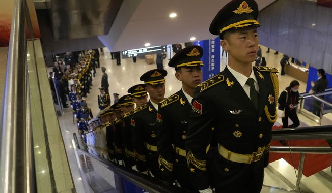 Members of a Chinese honor guard ride an escalator at the 10th Beijing Xiangshan Forum held in Beijing, Monday, Oct. 30, 2023. The Beijing event, attended by military representatives from dozens of countries, is an occasion for China to project regional leadership and boost military cooperation. (AP Photo/Ng Han Guan)