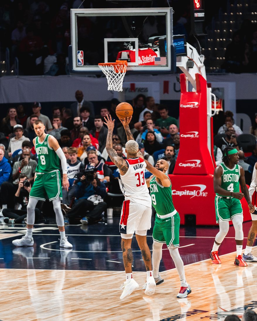 Washington, D.C.: Kyle Kuzma (33) shoots a three-point shot over defender Derrick White (9) The Washington Wizards fall to the Boston Celtics in their second home game of the season from Capital One Arena in Washington, DC on October 30th, 2023. (Photo: Jordan Sabillo | Washington Times Sports)