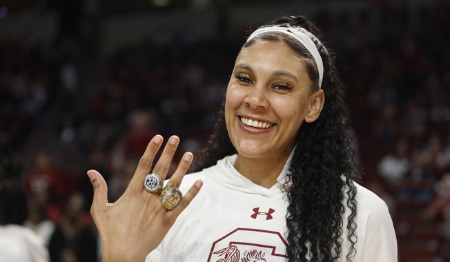South Carolina center Kamilla Cardoso shows off her rings as the 2022 women&#x27;s national championship team receive their rings before an an NCAA college basketball game in Columbia, S.C., Nov. 7, 2022. South Carolina 6-foot-7 center Kamilla Cardoso has been content the past two seasons playing in the shadow of All-American teammate Aliyah Boston. Now, Cardoso must step into the spotlight and be as dominant as Boston if the Gamecocks hope to continue contending for championships. It&#x27;s a role Cardoso&#x27;s coach Dawn Staley, her teammates and others say she&#x27;s been building toward the past few years. (AP Photo/Nell Redmond, File)