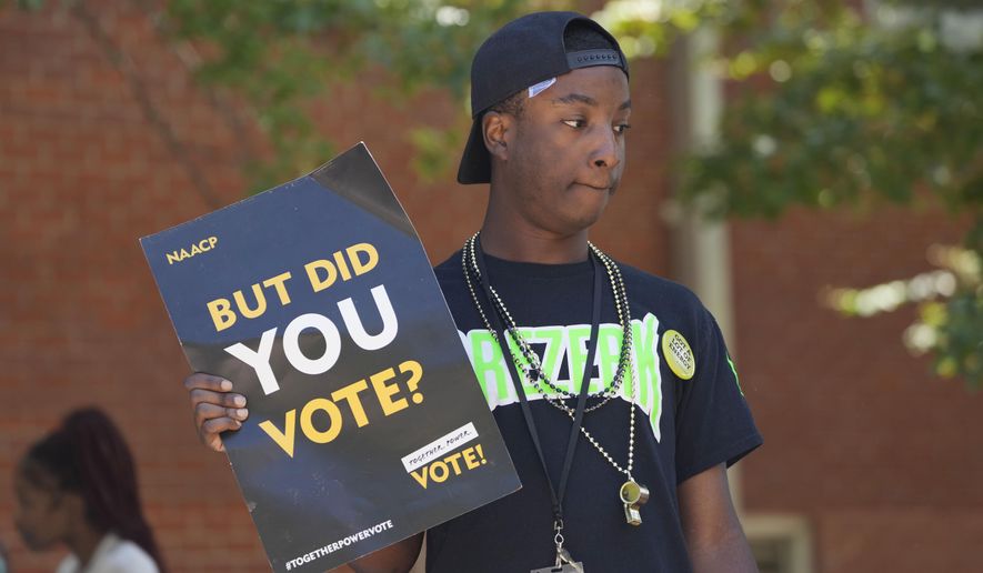 A Jackson State University student holds a sign stressing the importance of voting during a JSU Votes Civic Engagement Initiative on National Voter Registration Day, Sept. 19, 2023, on the Jackson, Miss., campus. According to information from the Mississippi Secretary of State's Office, the number of registered voters in the state has remained steady during the months leading to the Nov. 7 election for governor and other offices. (AP Photo/Rogelio V. Solis, File)