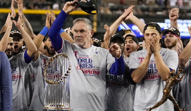 Texas Rangers manager Bruce Bochy celebrates with the trophy after winning Game 5 of the baseball World Series against the Arizona Diamondbacks Wednesday, Nov. 1, 2023, in Phoenix. The Rangers won 5-0 to win the series 4-1. (AP Photo/Brynn Anderson)