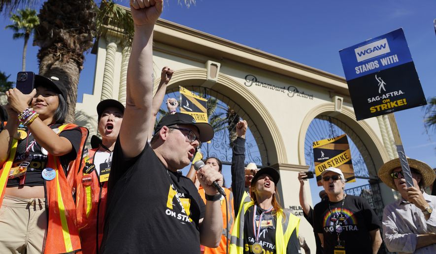 SAG-AFTRA chief negotiator Duncan Crabtree-Ireland, left, rallies striking actors in outside Paramount Pictures studio, Friday, Nov. 3, 2023, in Los Angeles. (AP Photo/Chris Pizzello)
