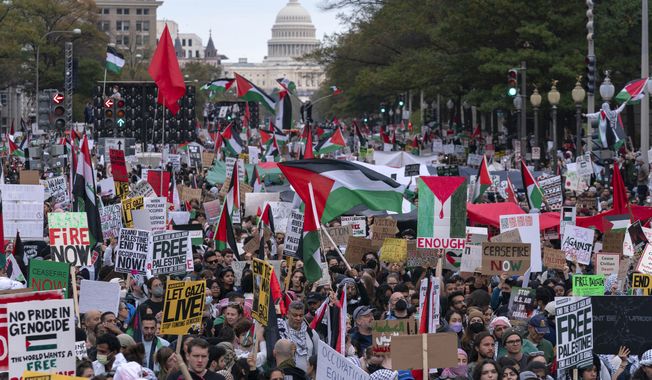 With the U.S Capitol n the background thousands of protesters rally during a pro-Palestinian demonstration at Freedom Plaza in Washington, Saturday, Nov. 4, 2023.(AP Photo/Jose Luis Magana)