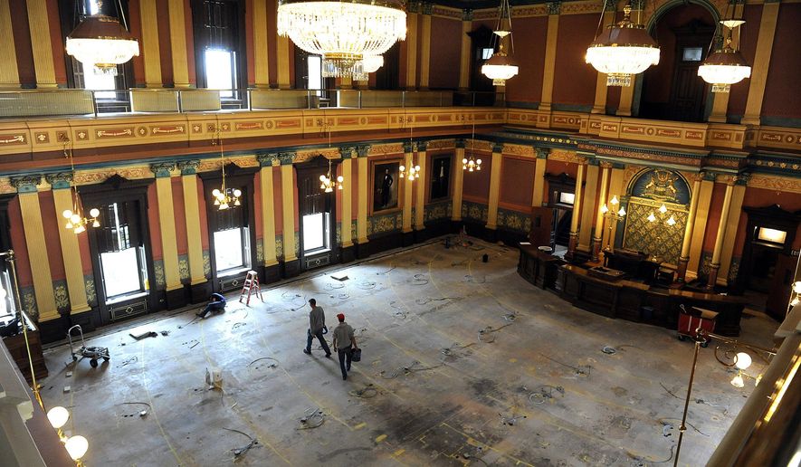 In a July 2, 2013 photo, workmen walk on the floor of the House of Representatives in the Capitol building in Lansing, Mich. Two mayoral races taking place on Tuesday, Nov. 7, 2023 could put Michigan Democrats' full control of the state government temporarily on hold. Democrats currently hold a two-seat majority in the state House and two Democratic representatives, Lori Stone and Kevin Coleman, are running for mayor in their districts. (Rod Sanford/Lansing State Journal via AP)