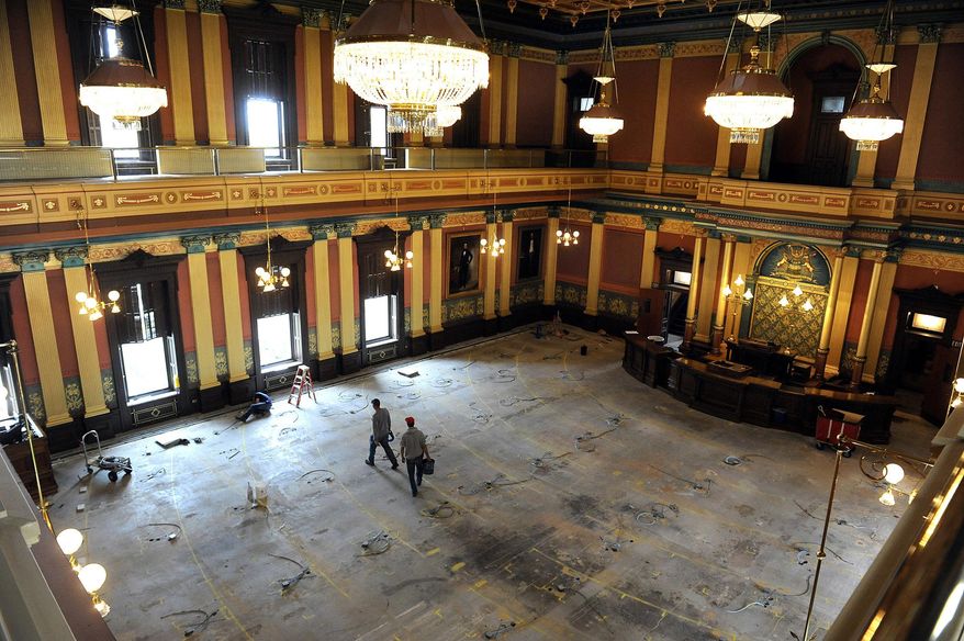 In a July 2, 2013 photo, workmen walk on the floor of the House of Representatives in the Capitol building in Lansing, Mich. Two mayoral races taking place on Tuesday, Nov. 7, 2023 could put Michigan Democrats' full control of the state government temporarily on hold. Democrats currently hold a two-seat majority in the state House and two Democratic representatives, Lori Stone and Kevin Coleman, are running for mayor in their districts. (Rod Sanford/Lansing State Journal via AP)