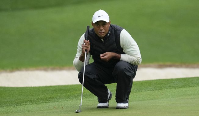 Tiger Woods lines up a putt on the 16th hole during the weather delayed second round of the Masters golf tournament at Augusta National Golf Club Saturday, April 8, 2023, in Augusta, Ga. Woods says his right ankle that was fused in April is pain-free, but other parts of his leg are not. (AP Photo/Mark Baker, File) **FILE**