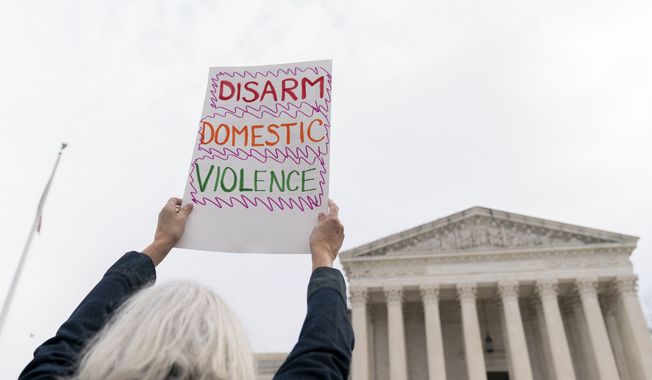 Gun safety and domestic violence prevention organizations gather outside of the Supreme Court before oral arguments are heard in United States v. Rahimi, Tuesday, Nov. 7, 2023, in Washington. (AP Photo/Stephanie Scarbrough)