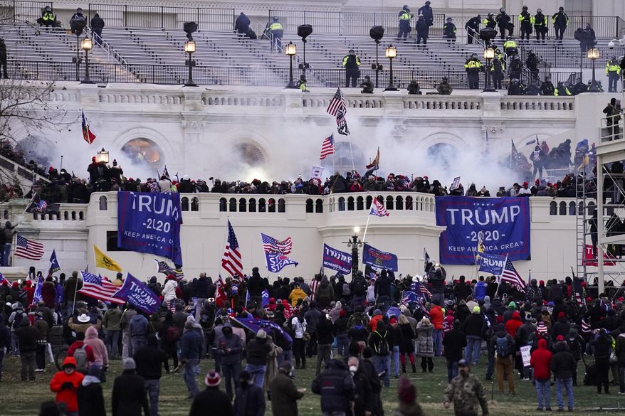 Violent rioters loyal to President Donald Trump storm the Capitol in Washington on Jan. 6, 2021. Four California men linked to the “Three Percenters” militia movement have been convicted on charges including conspiracy and obstruction for their roles in the Jan. 6, 2021 riot at the U.S. Capitol. Erik Scott Warner, Felipe Antonio Martinez, Derek Kinnison, and Ronald Mele were found guilty on Tuesday after a trial in Washington’s federal court. (AP Photo/John Minchillo, File)