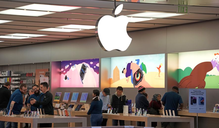 Customers shop in an Apple store in Pittsburgh Jan. 30, 2023. Apple reports earnings on Thursday, Nov. 2, 2023. (AP Photo/Gene J. Puskar, File)