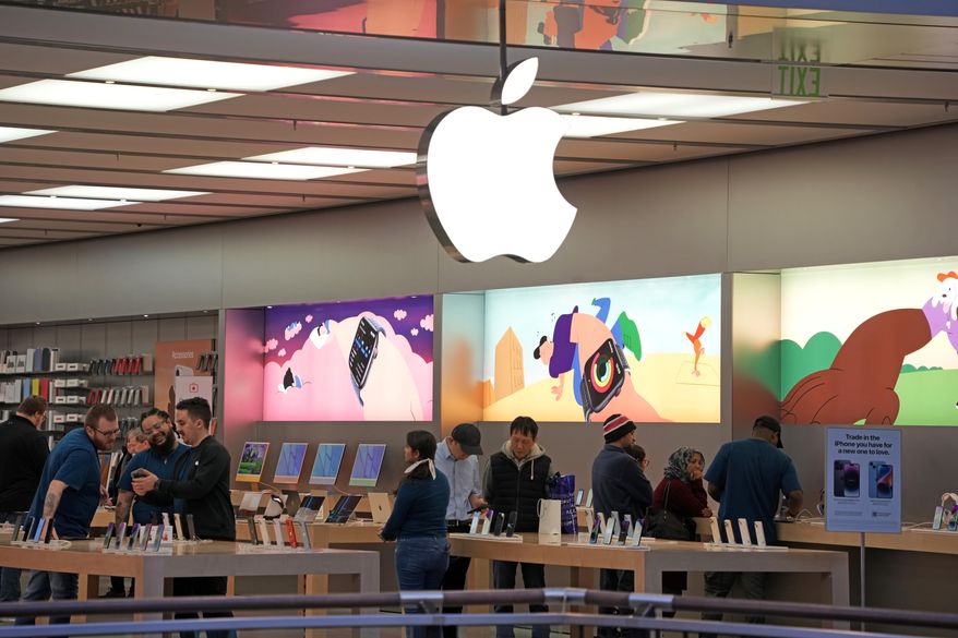 Customers shop in an Apple store in Pittsburgh Jan. 30, 2023. Apple reports earnings on Thursday, Nov. 2, 2023. (AP Photo/Gene J. Puskar, File)